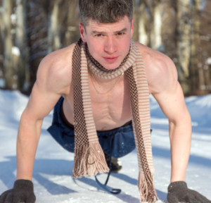 Young sportsman doing push-ups on snow